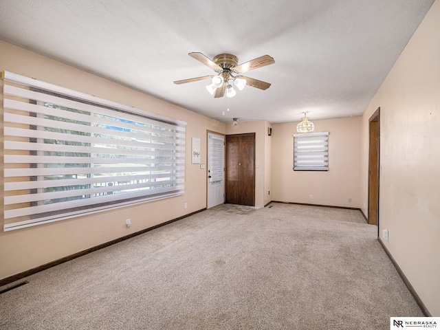 9418 Meredith Ave, Omaha, NE 68134 - spare room featuring carpet and a ceiling fan