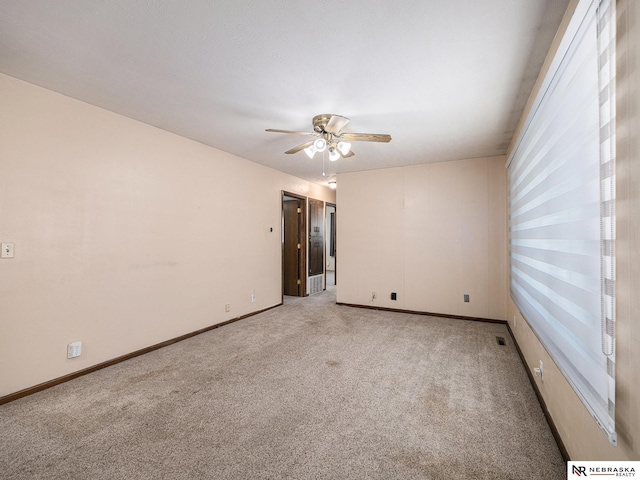 9418 Meredith Ave, Omaha, NE 68134 - spare room with light colored carpet and ceiling fan