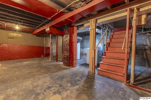 6316 Spencer St, Omaha, NE 68104 - unfinished below grade area with stairs, water heater, and brick wall