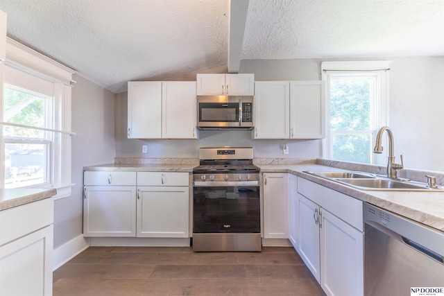 6316 Spencer St, Omaha, NE 68104 - kitchen featuring appliances with stainless steel finishes, a textured ceiling, light wood-type flooring, white cabinets, and light countertops