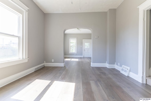 6316 Spencer St, Omaha, NE 68104 - unfurnished room featuring arched walkways, ceiling fan, and wood finished floors