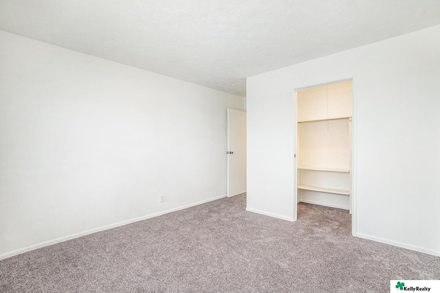 13229 Glenn St, Omaha, NE 68138 - unfurnished bedroom with a walk in closet, carpet flooring, and a closet