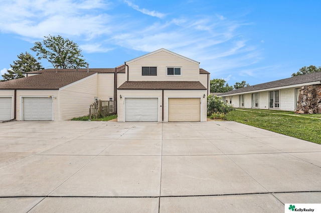13229 Glenn St, Omaha, NE 68138 - view of home's exterior featuring driveway, a garage, and a lawn