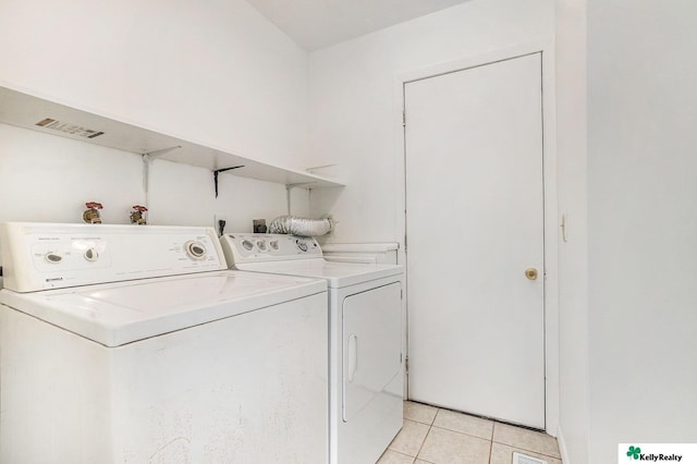 13229 Glenn St, Omaha, NE 68138 - laundry area featuring washer and clothes dryer and light tile patterned flooring