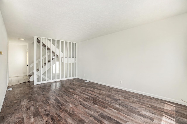 13229 Glenn St, Omaha, NE 68138 - spare room with dark wood-style floors and a textured ceiling