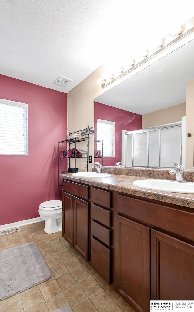 14210 Potter Pkwy, Omaha, NE 68142 - bathroom featuring double vanity, healthy amount of natural light, and a shower stall