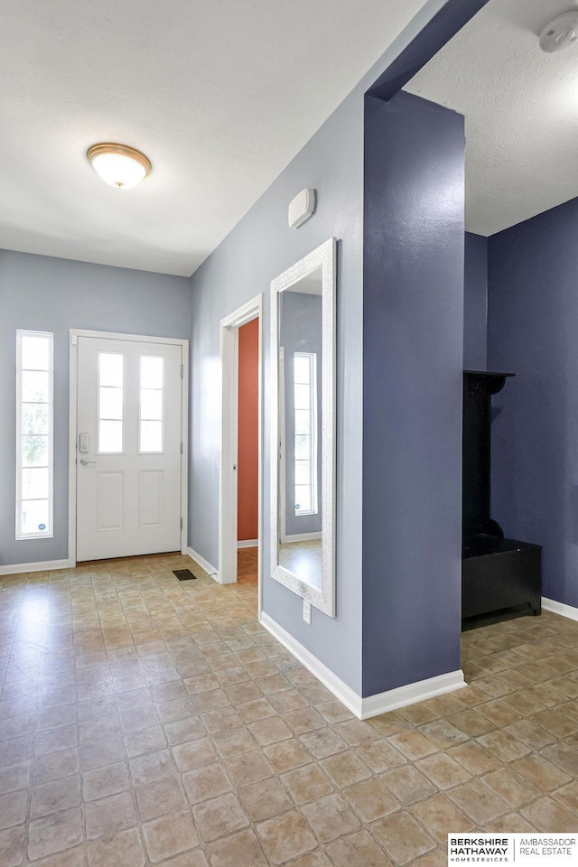 14210 Potter Pkwy, Omaha, NE 68142 - entryway with baseboards and a wood stove