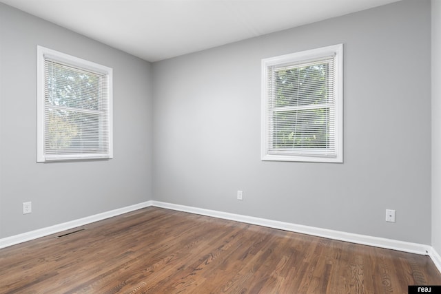 12529 C St, Omaha, NE 68144 - spare room featuring healthy amount of natural light and dark wood-style floors