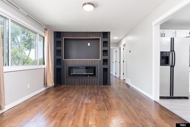 12529 C St, Omaha, NE 68144 - unfurnished living room featuring wood finished floors and a glass covered fireplace