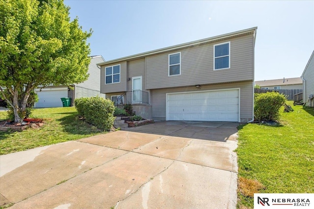 6961 N 89th Ave, Omaha, NE 68122 - raised ranch with an attached garage, a front yard, and concrete driveway