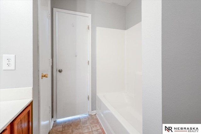 6961 N 89th Ave, Omaha, NE 68122 - full bathroom with vanity, bathtub / shower combination, and stone finish floors