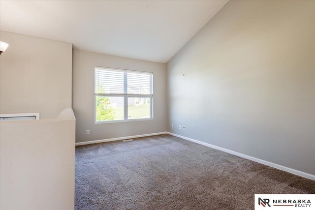 6961 N 89th Ave, Omaha, NE 68122 - carpeted spare room featuring baseboards and lofted ceiling