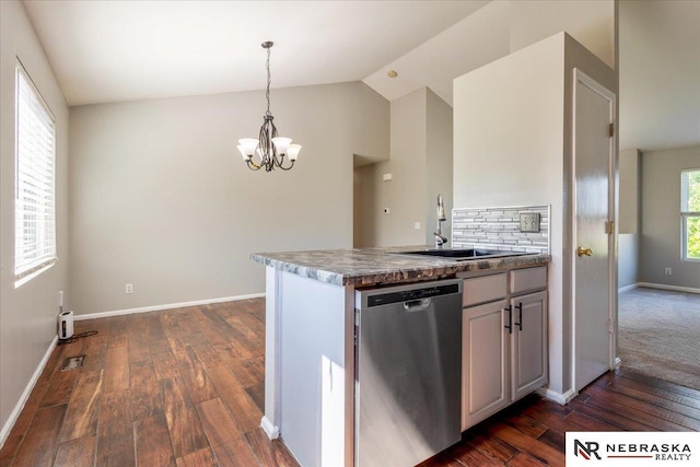 6961 N 89th Ave, Omaha, NE 68122 - kitchen with stainless steel dishwasher, a chandelier, dark wood finished floors, vaulted ceiling, and pendant lighting