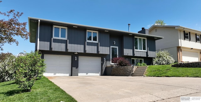 10912 V St, Omaha, NE 68137 - bi-level home with an attached garage, driveway, and a chimney