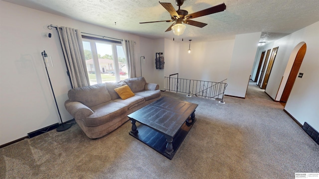 10912 V St, Omaha, NE 68137 - living room featuring arched walkways, a textured ceiling, carpet flooring, and ceiling fan