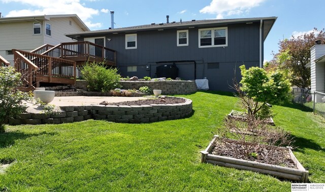 10912 V St, Omaha, NE 68137 - back of property with a wooden deck, a vegetable garden, and stairway