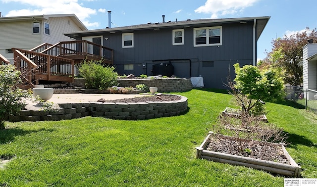 10912 V St, Omaha, NE 68137 - back of property with a wooden deck, a vegetable garden, and stairway