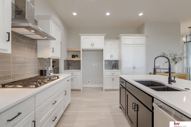 5608 N 212th St, Elkhorn, NE 68022 - kitchen with wall chimney range hood, appliances with stainless steel finishes, tasteful backsplash, light countertops, and white cabinetry
