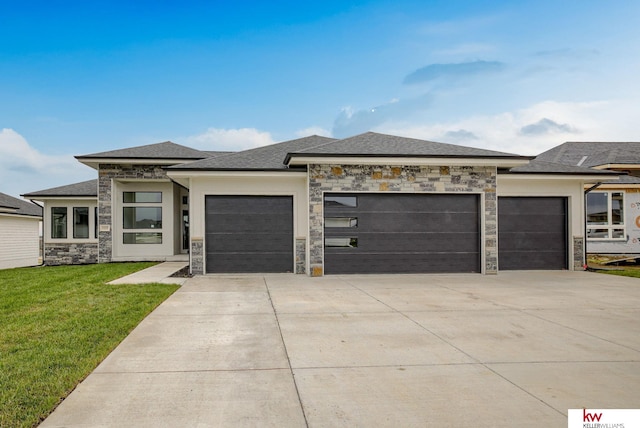 5608 N 212th St, Elkhorn, NE 68022 - prairie-style home featuring an attached garage, concrete driveway, a front lawn, and stone siding