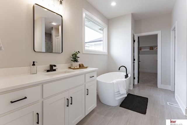 5608 N 212th St, Elkhorn, NE 68022 - bathroom with vanity and a freestanding tub