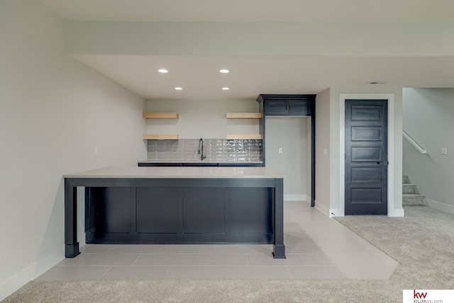 5608 N 212th St, Elkhorn, NE 68022 - kitchen with light countertops, recessed lighting, backsplash, light carpet, and a peninsula