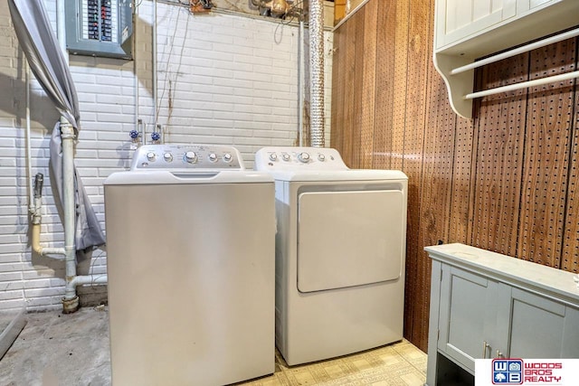 5951 Oakridge Dr, Lincoln, NE 68516 - laundry room with washing machine and clothes dryer and cabinet space