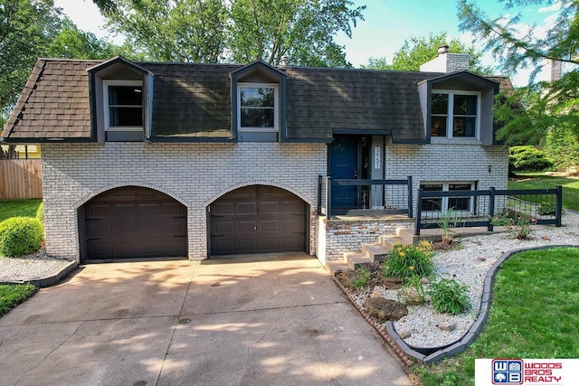 5951 Oakridge Dr, Lincoln, NE 68516 - bi-level home featuring brick siding, a garage, concrete driveway, and a chimney