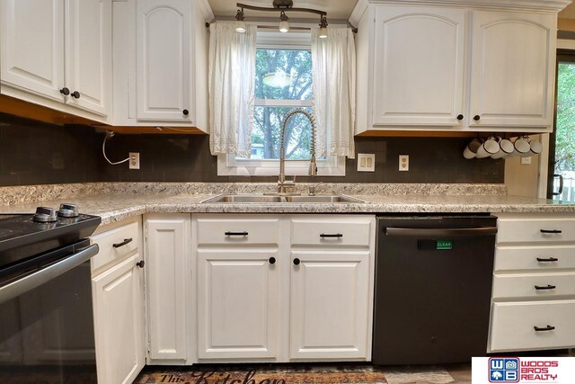 5951 Oakridge Dr, Lincoln, NE 68516 - kitchen with dishwashing machine, white cabinets, light countertops, and tasteful backsplash