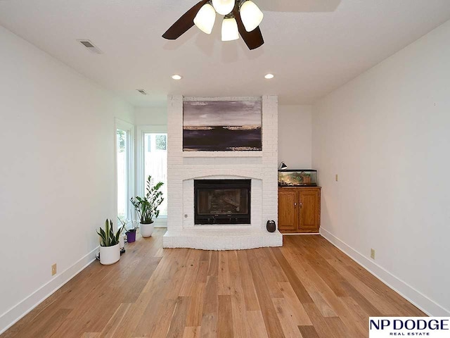 724 N 155th Ave, Omaha, NE 68154 - unfurnished living room with a brick fireplace, wood finished floors, recessed lighting, and ceiling fan
