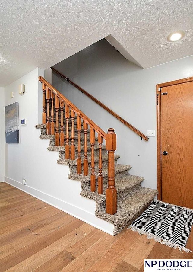 724 N 155th Ave, Omaha, NE 68154 - stairs featuring wood finished floors and a textured ceiling