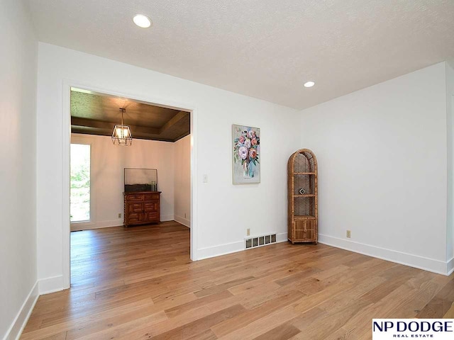 724 N 155th Ave, Omaha, NE 68154 - unfurnished room featuring light wood-style flooring, a chandelier, and recessed lighting