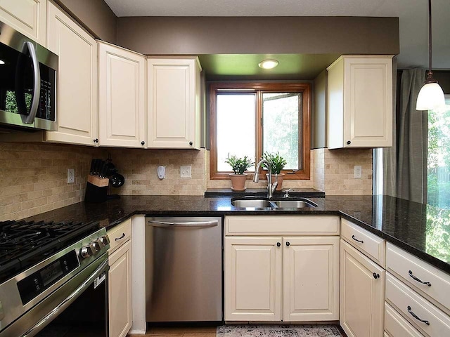724 N 155th Ave, Omaha, NE 68154 - kitchen with appliances with stainless steel finishes, white cabinets, tasteful backsplash, and dark stone counters