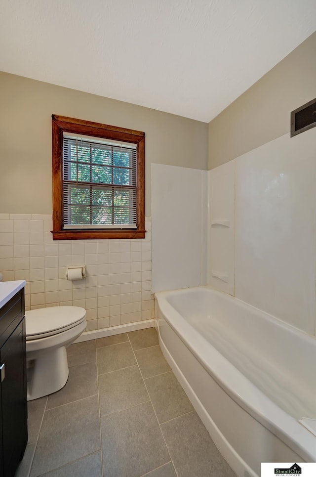 4415 S St, Lincoln, NE 68506 - full bathroom featuring tile walls, vanity, tile patterned floors, and a wainscoted wall