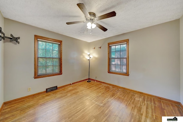 4415 S St, Lincoln, NE 68506 - unfurnished room featuring wood finished floors, a textured ceiling, and a ceiling fan