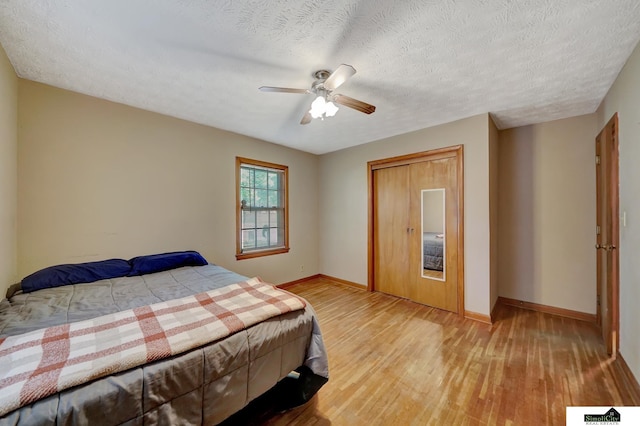 4415 S St, Lincoln, NE 68506 - bedroom with wood finished floors, ceiling fan, and a textured ceiling