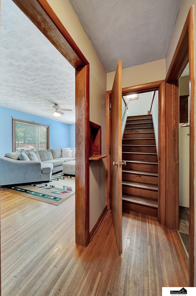 4415 S St, Lincoln, NE 68506 - stairway with hardwood / wood-style floors, ceiling fan, and a textured ceiling