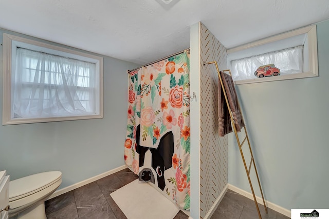4415 S St, Lincoln, NE 68506 - full bath with plenty of natural light, curtained shower, and tile patterned flooring