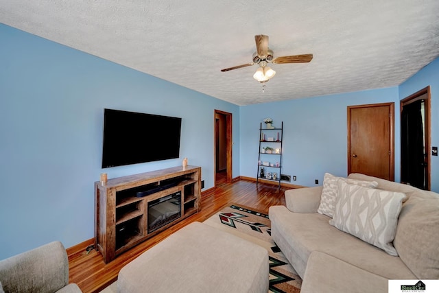 4415 S St, Lincoln, NE 68506 - living area with wood finished floors, a textured ceiling, and a ceiling fan
