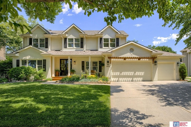 6030 S 74th St, Lincoln, NE 68516 - traditional home with a garage, a front yard, concrete driveway, and brick siding