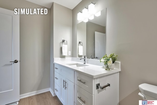 246 N 105th St, Lincoln, NE 68527 - bathroom featuring vanity and wood finished floors
