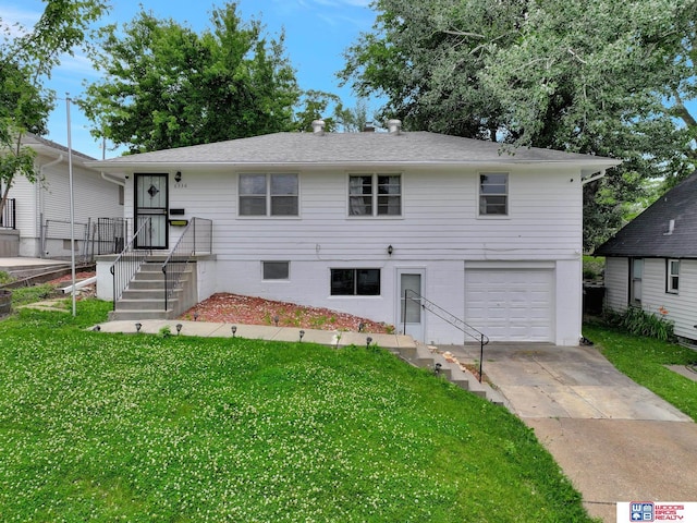 6336 N 37th St, Omaha, NE 68111 - view of front of house with a garage, a front yard, and concrete driveway