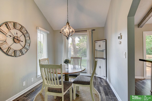11122 Jefferson St, Omaha, NE 68137 - dining space with dark wood finished floors, a chandelier, and lofted ceiling