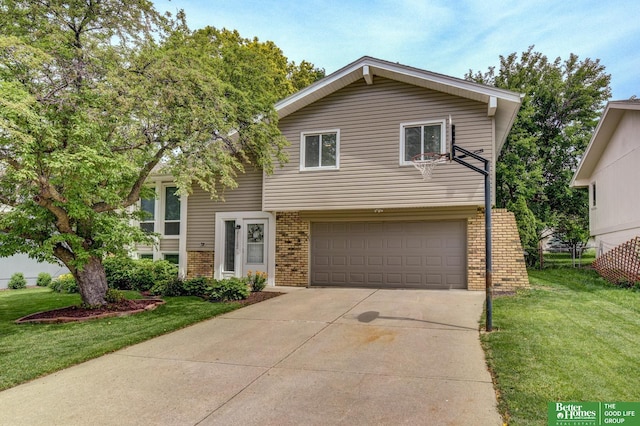 11122 Jefferson St, Omaha, NE 68137 - view of front facade with brick siding, a garage, a front yard, and concrete driveway