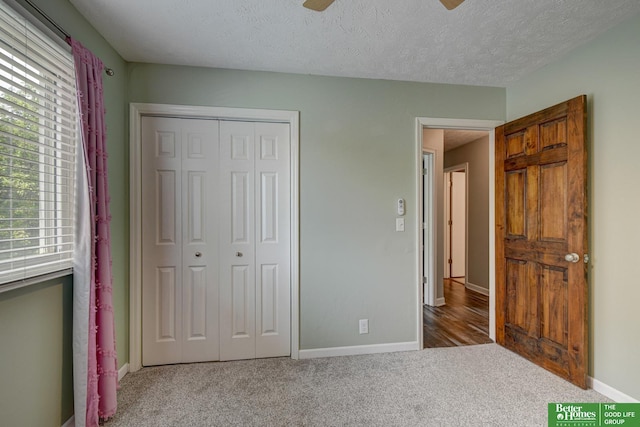 11122 Jefferson St, Omaha, NE 68137 - unfurnished bedroom with multiple windows, a closet, carpet flooring, a textured ceiling, and ceiling fan