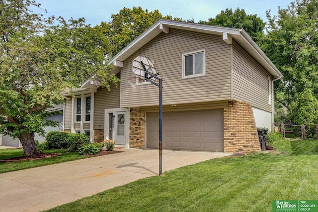 11122 Jefferson St, Omaha, NE 68137 - split level home with brick siding, an attached garage, and driveway