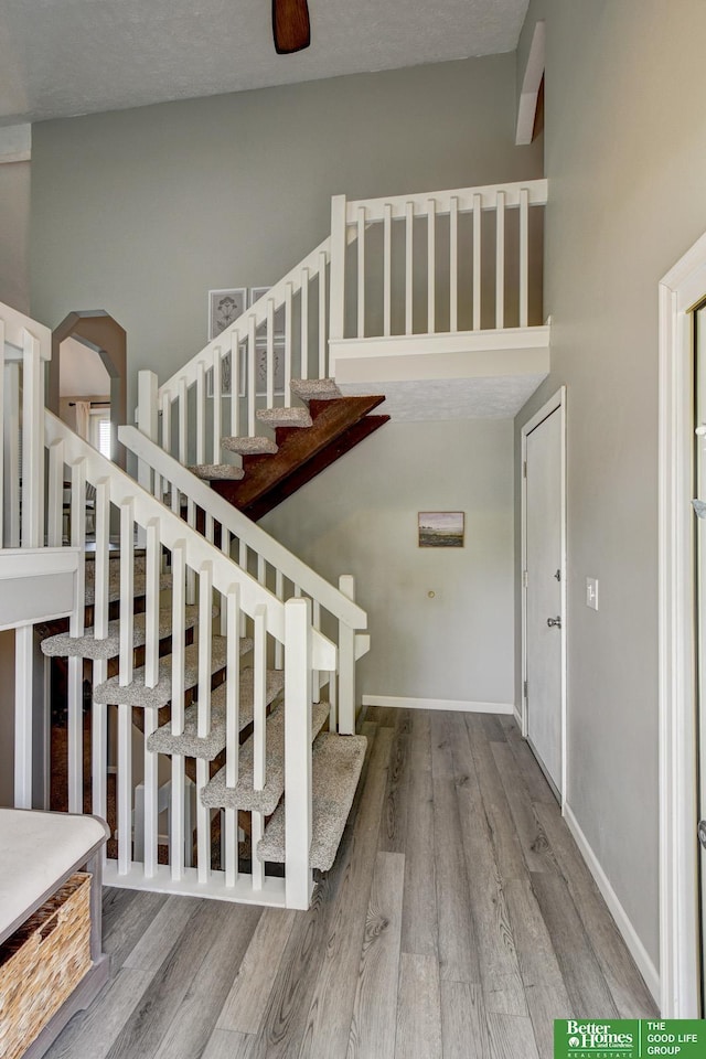 11122 Jefferson St, Omaha, NE 68137 - staircase with wood finished floors and arched walkways