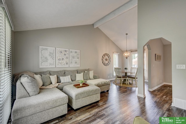 11122 Jefferson St, Omaha, NE 68137 - living area with arched walkways, beamed ceiling, dark wood-style floors, high vaulted ceiling, and a chandelier