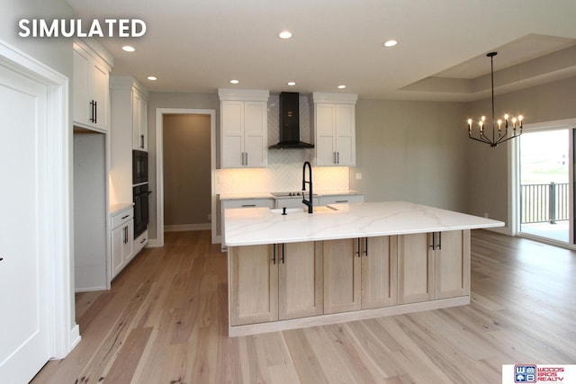 941 N 104th St, Lincoln, NE 68527 - kitchen with wall chimney range hood, light wood-style floors, backsplash, a chandelier, and a spacious island