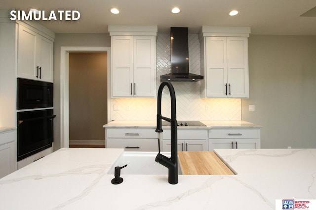 941 N 104th St, Lincoln, NE 68527 - kitchen featuring black appliances, wall chimney exhaust hood, white cabinetry, decorative backsplash, and recessed lighting