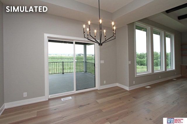 941 N 104th St, Lincoln, NE 68527 - unfurnished dining area featuring healthy amount of natural light, wood finished floors, and a chandelier